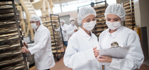 Workers wearing masks in a food production facility